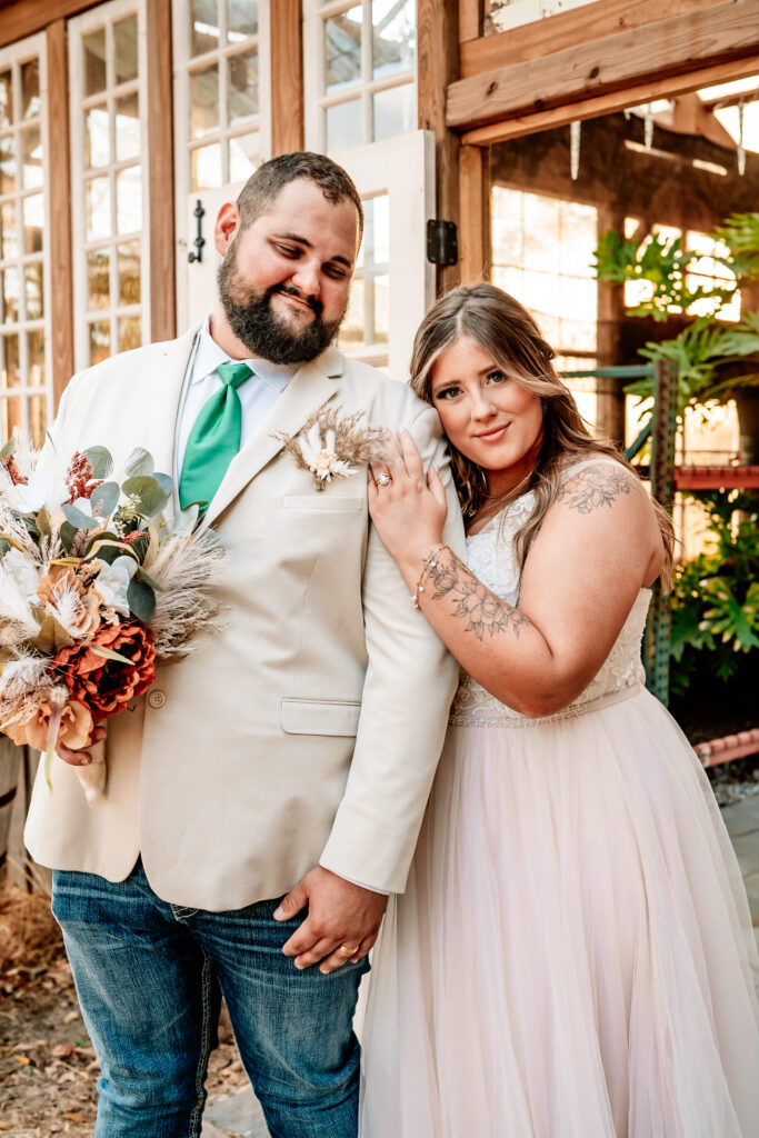 Bride and groom pose in a greenhouse in Newton, MS.